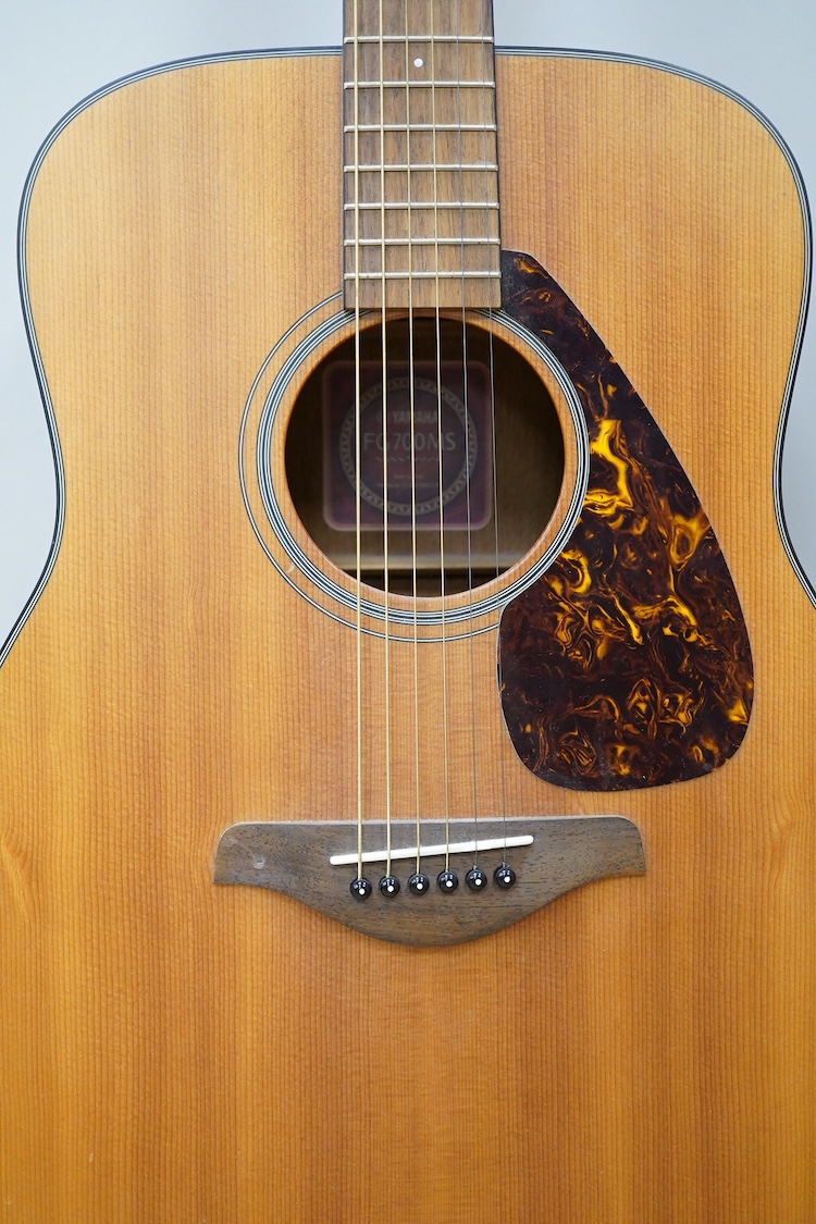 A Yamaha FG700MS acoustic guitar with a soft carry case